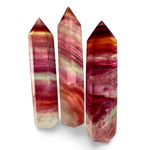 Three multicolored crystal sticks on a white background