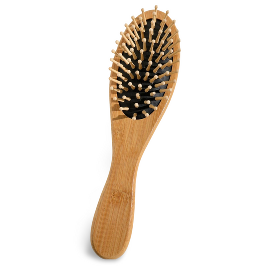 Wooden hairbrush with bristles on a white background
