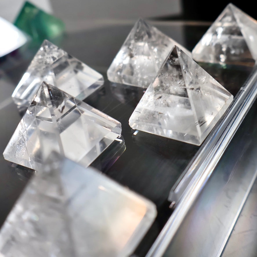 Clear crystal pyramids on a reflective surface
