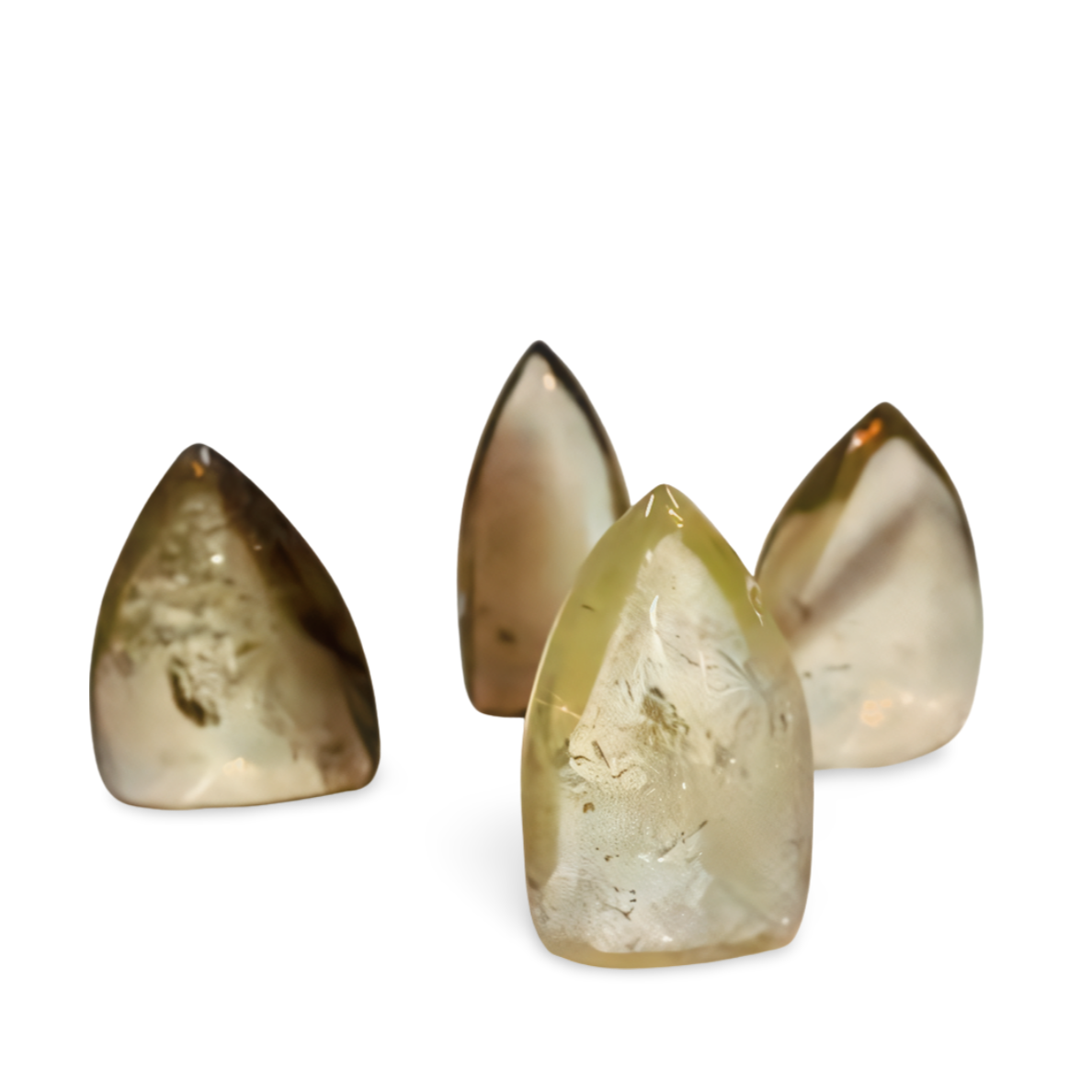 Four citrine crystals cone-shaped on a white background