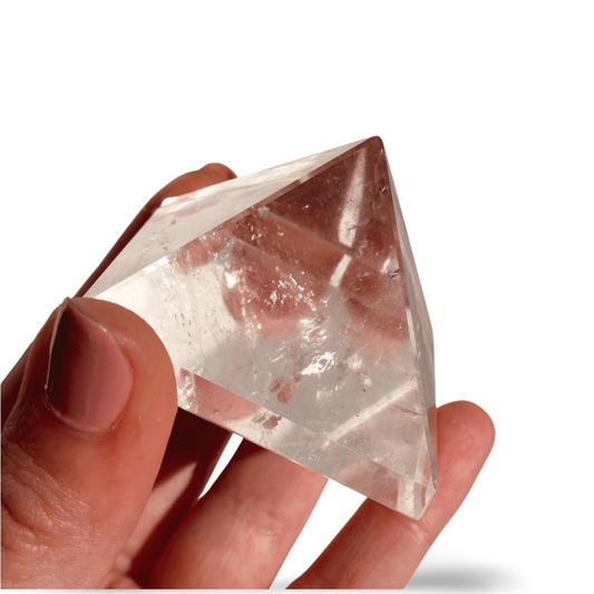 glimmering Clear Quartz Pyramid in studio background
