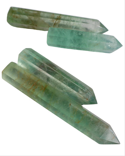 Green crystal points on a white surface