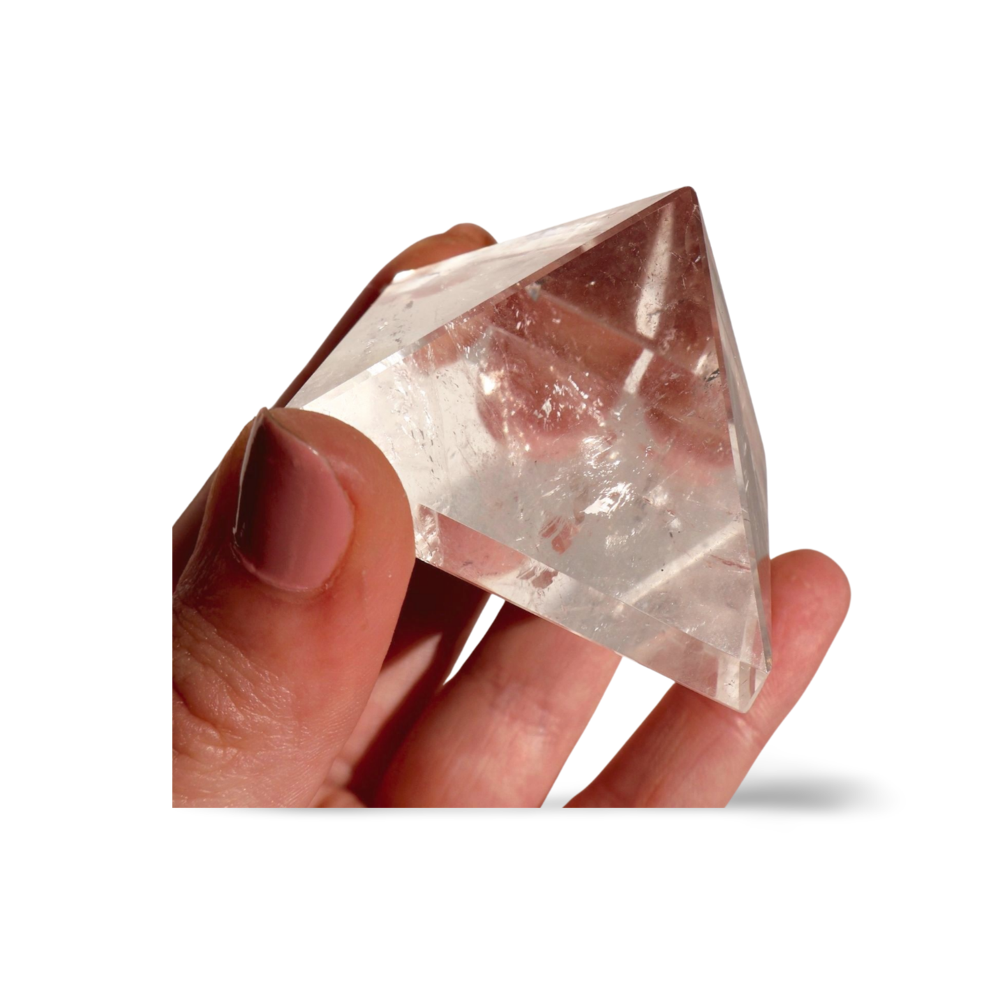 glimmering Clear Quartz Pyramid in studio background