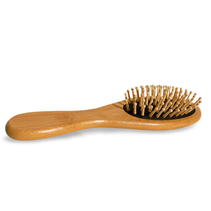 Wooden hairbrush with metal bristles on a white background