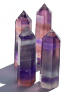 Three multicolored crystal points on a white background