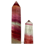 Two multicolored crystal obelisks on a white background
